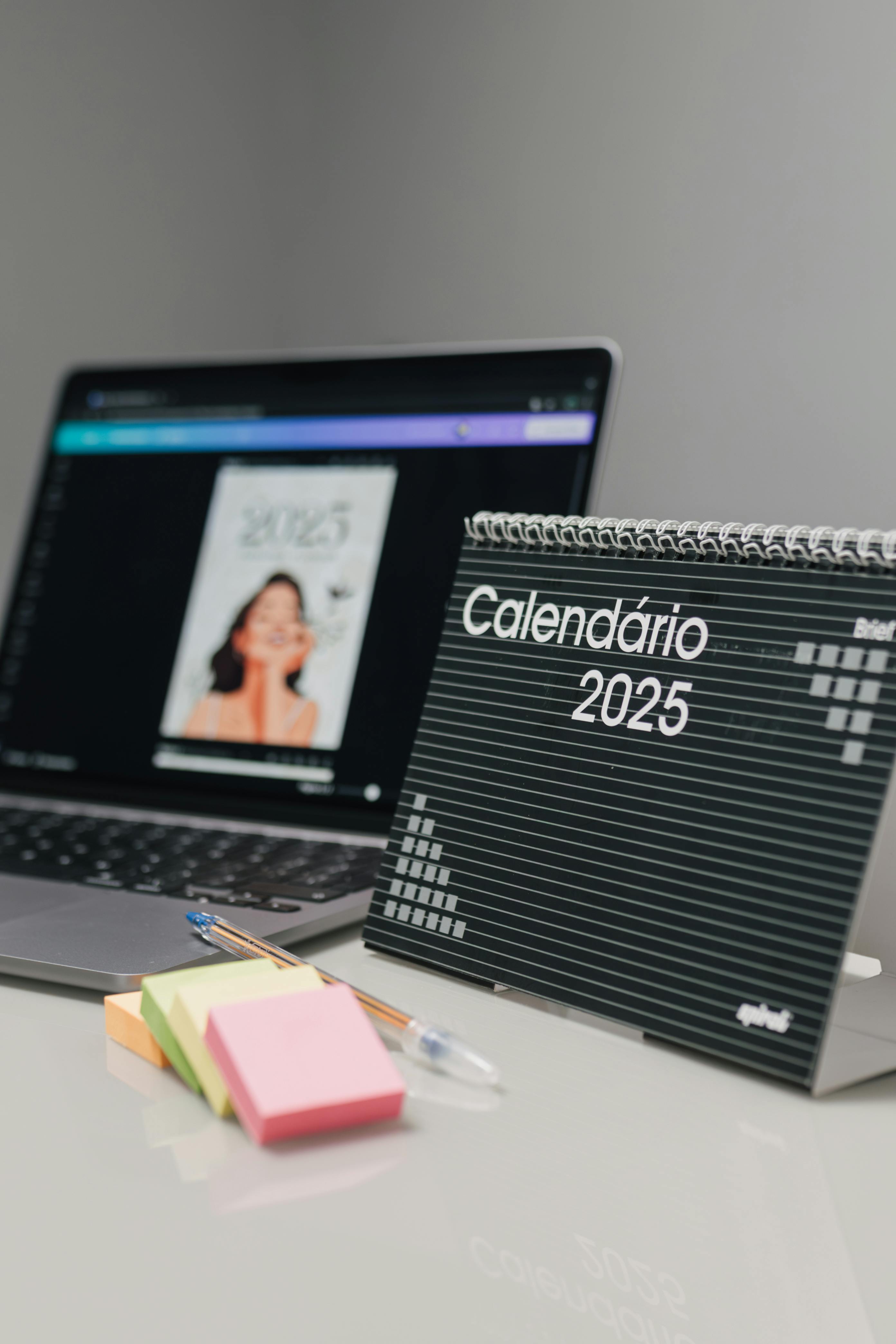 Desk with calendar, laptop, and planning materials