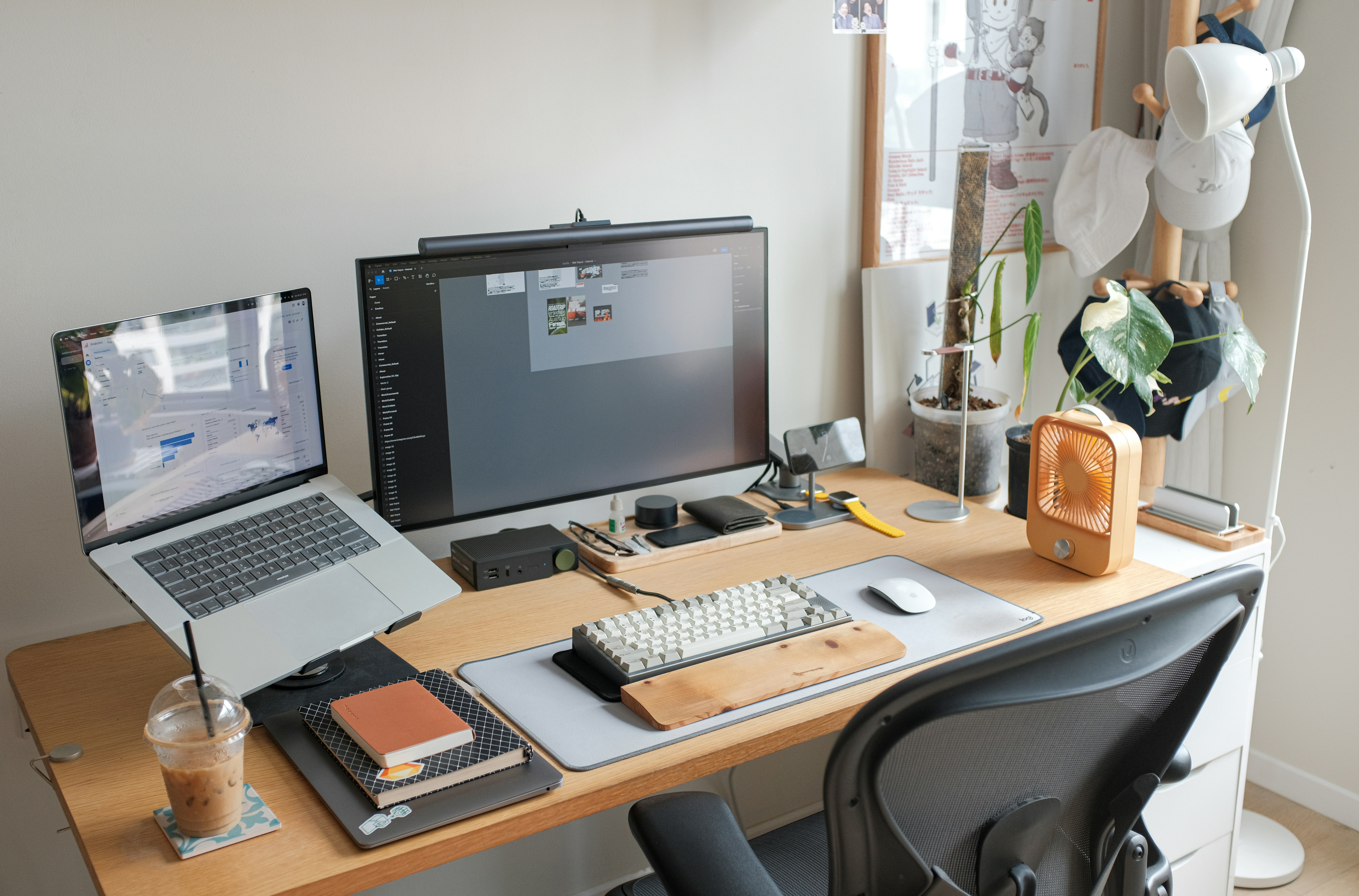 Professional desk setup with laptop and monitor for content production